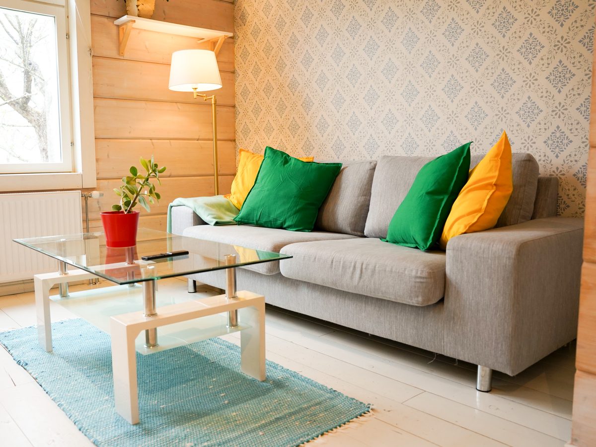 Köpmans Apartment living room — grey sofa with colourful cushions